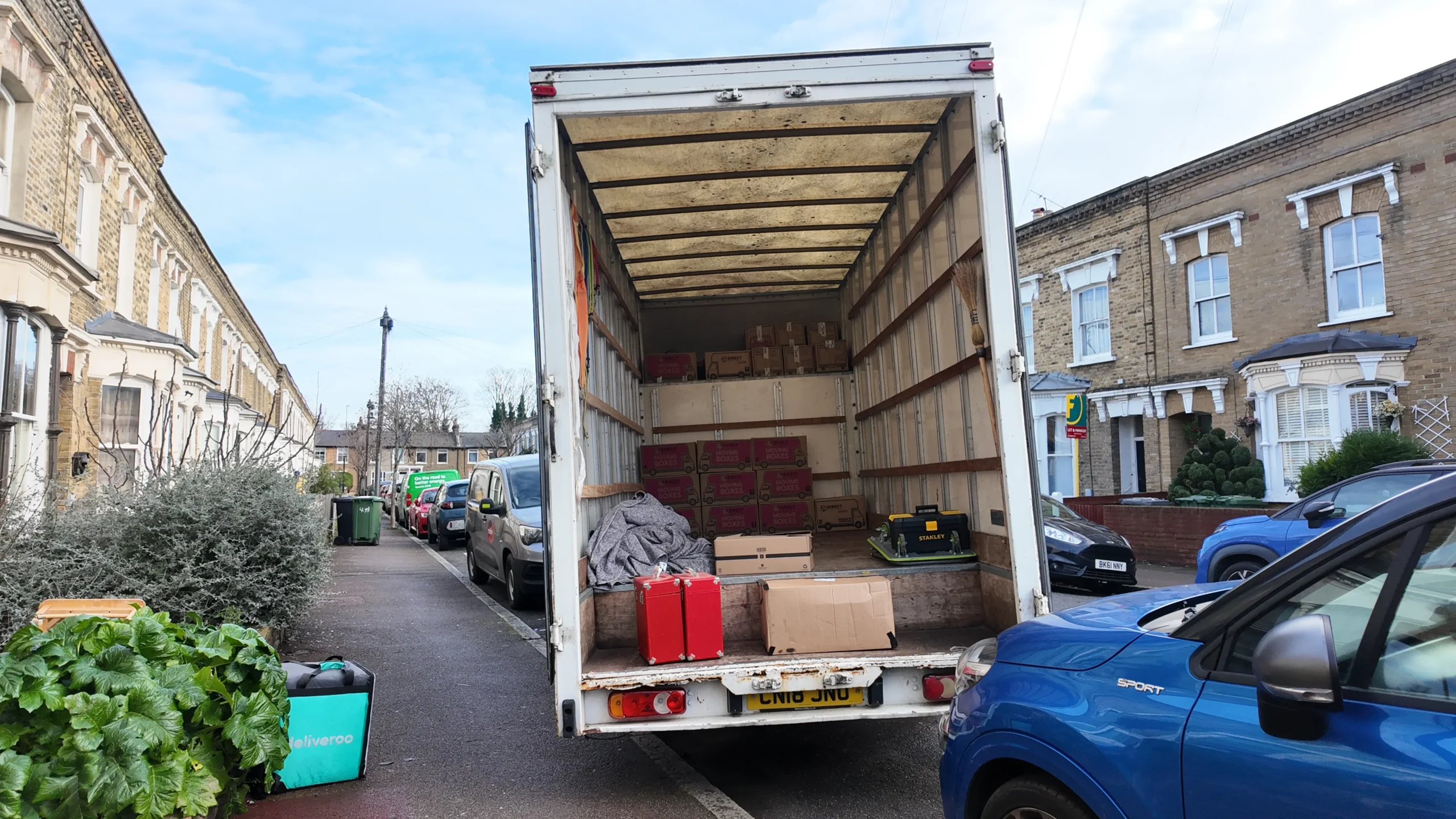 Luton van loaded with boxes on a London residential street