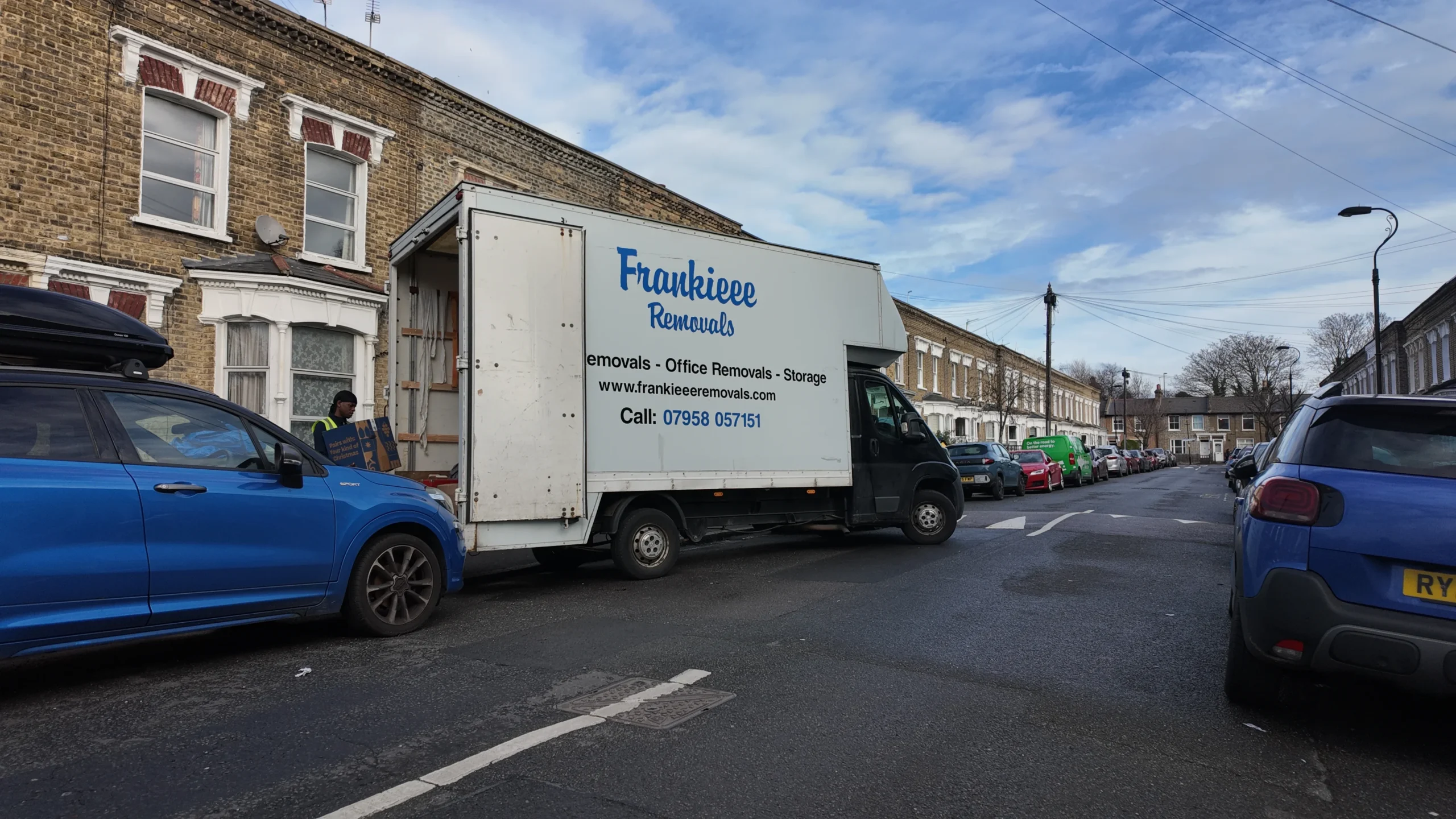 Frankieee Removals branded Luton van parked on a London street
