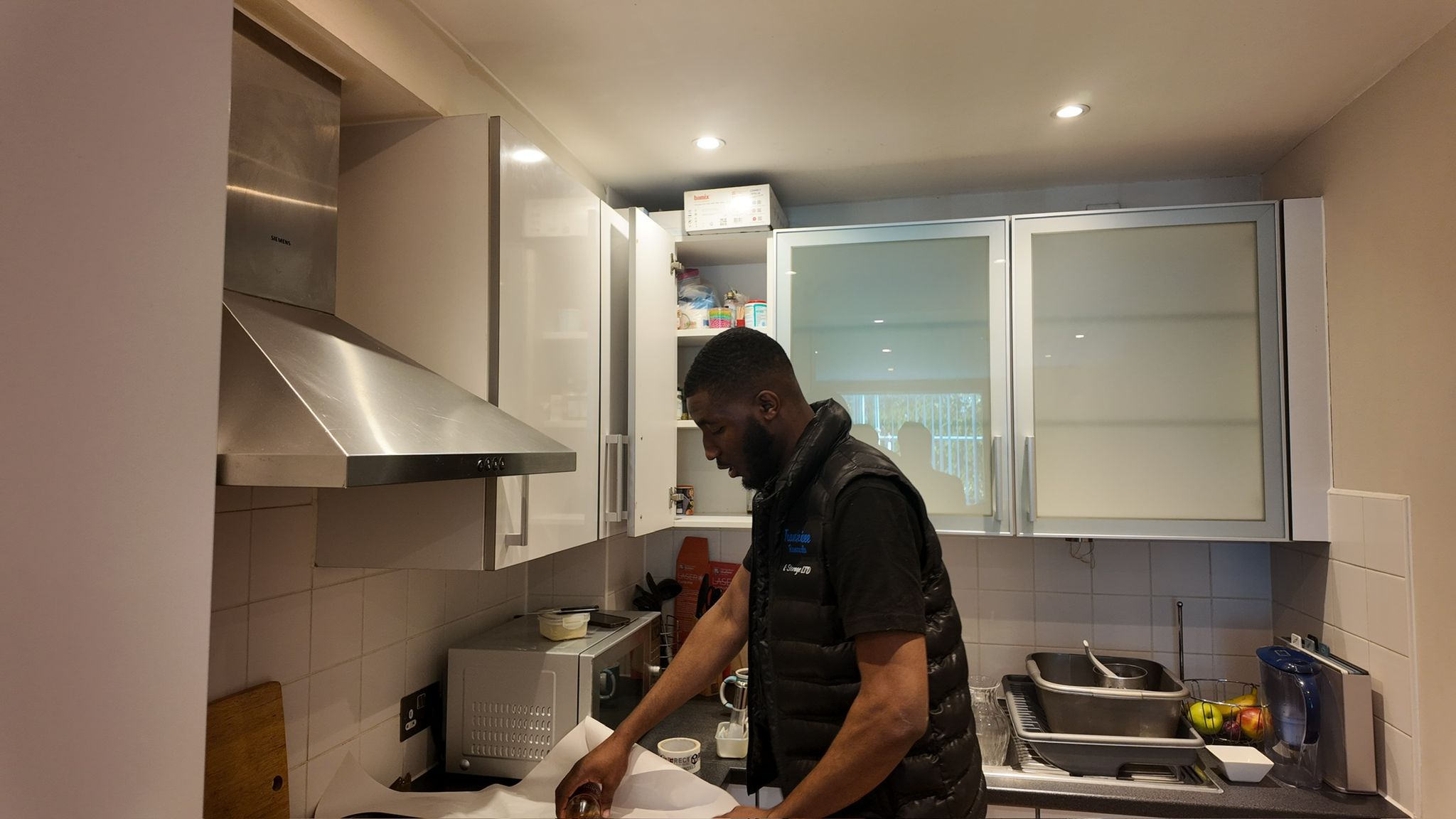 Crew member carefully packing kitchen items before a London move
