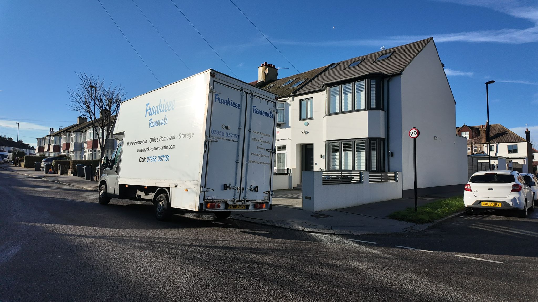 Open Luton van on a London street ready for a long-distance move