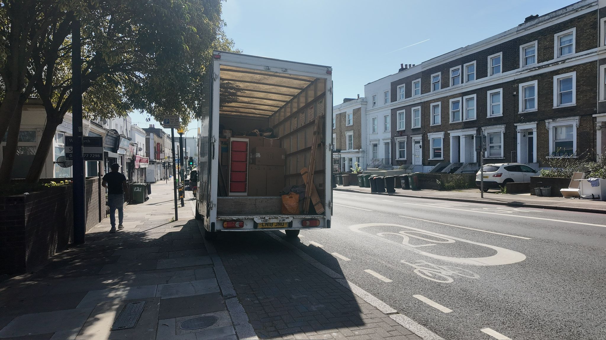 Open van being loaded on a London residential street